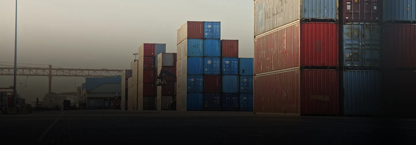 Shipping containers stacked in a logistics yard